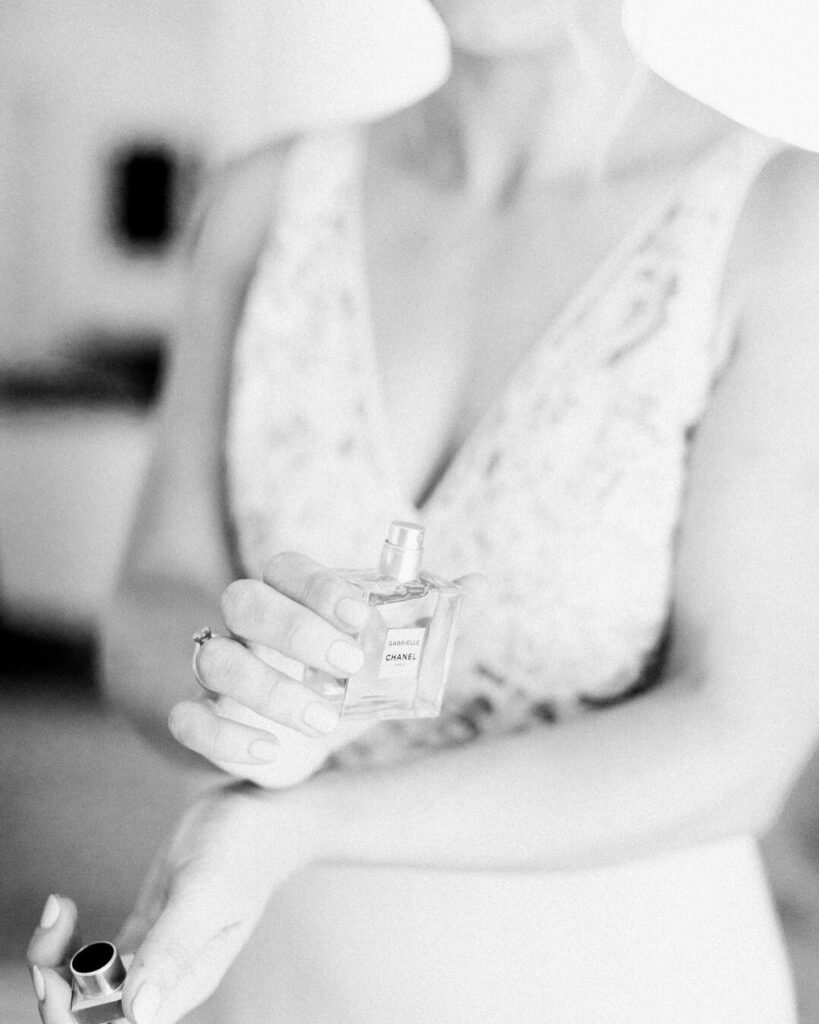 bride spraying Chanel No. 5 perfume, wedding day details by Boston wedding photographer Ashley Helen