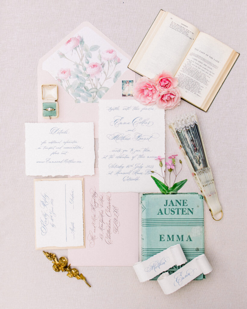 pink and ivory invitaton suite and wedding day details, with fan and vintage book