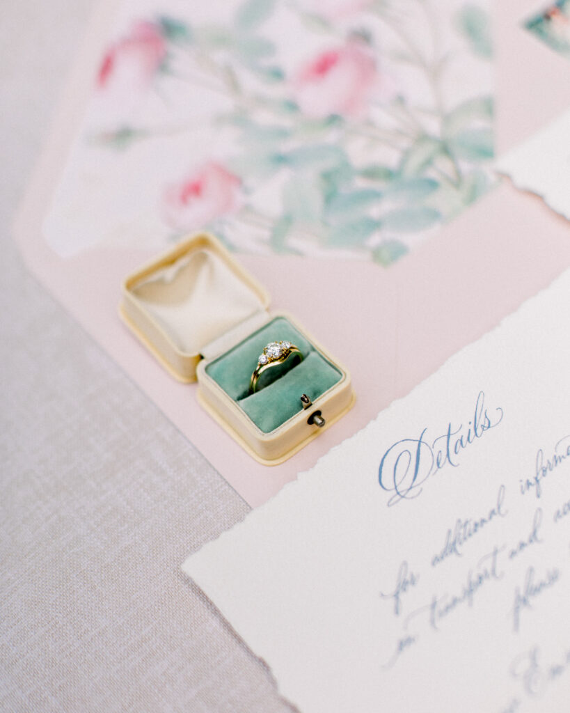 engagement ring in a vintage ring box, with wedding invitation and envelope with english rose liner, wedding day details by Boston wedding photographer Ashley Helen