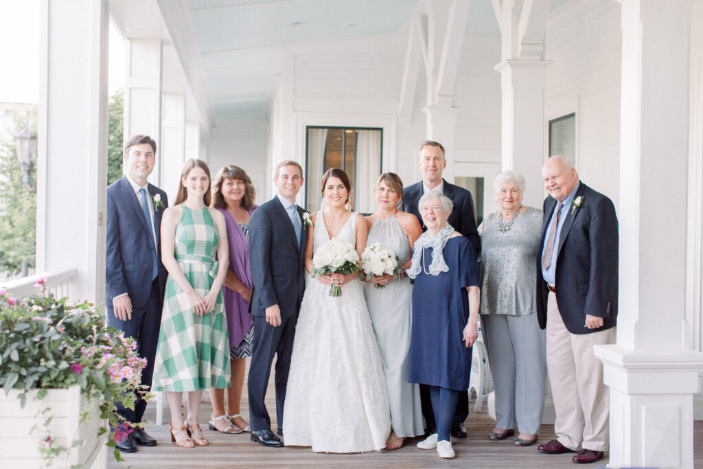 large family grouping with wedding couple on a front porch